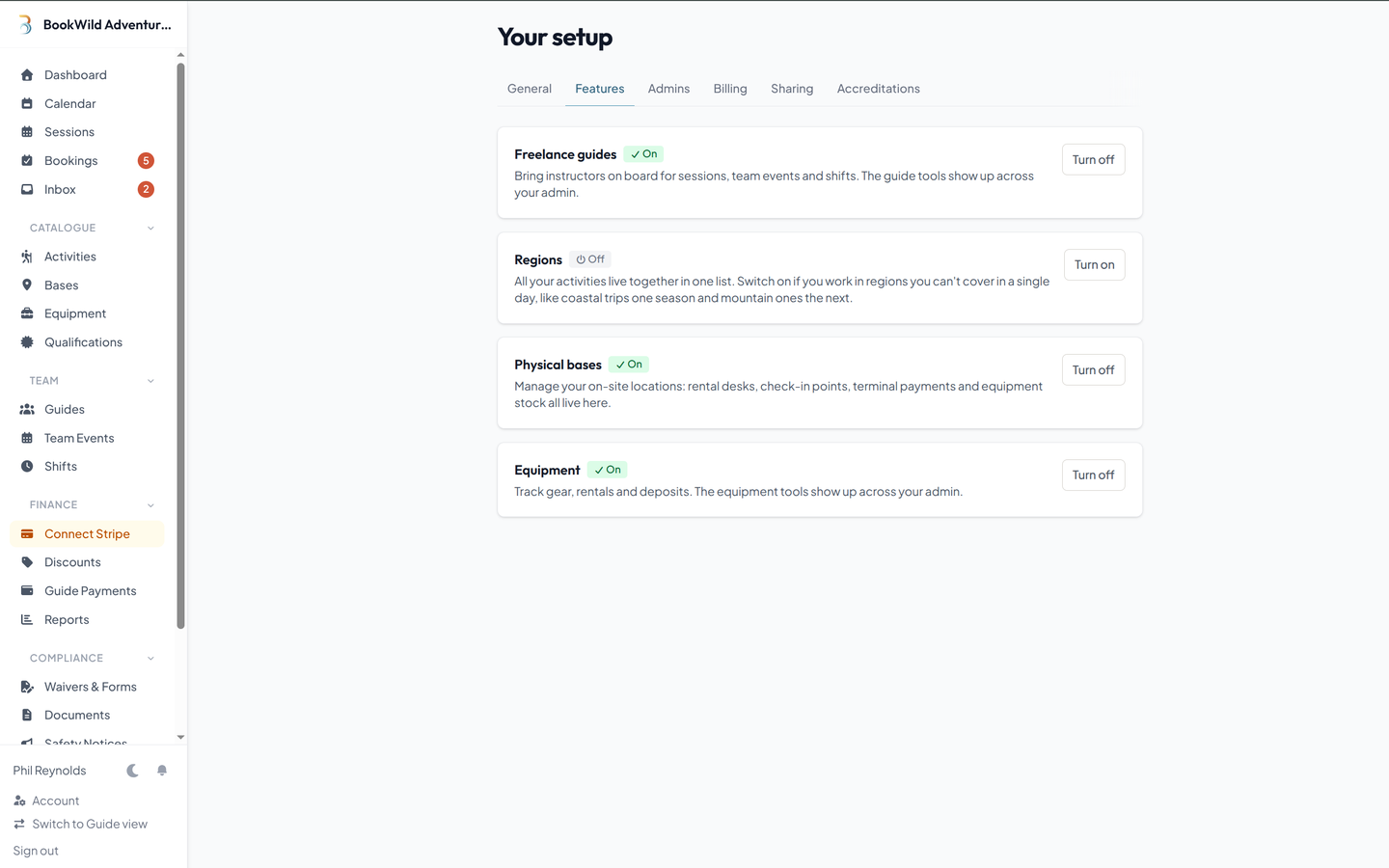 BookWild Settings — Features tab with on/off cards for freelance guides, regions, physical bases, and equipment